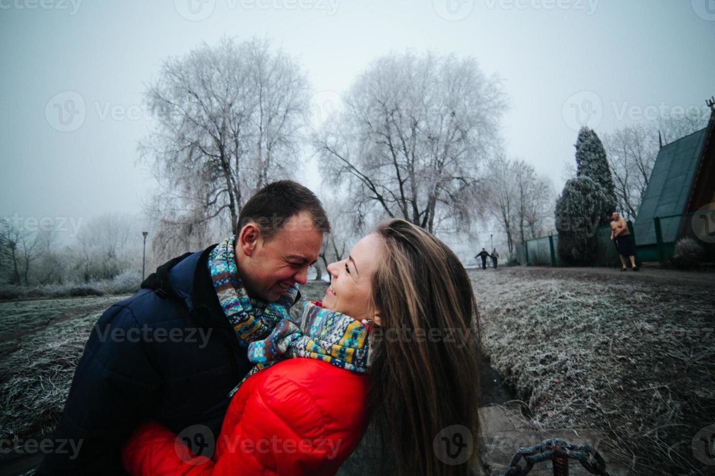 beautiful couple is standing on a small bridge photo