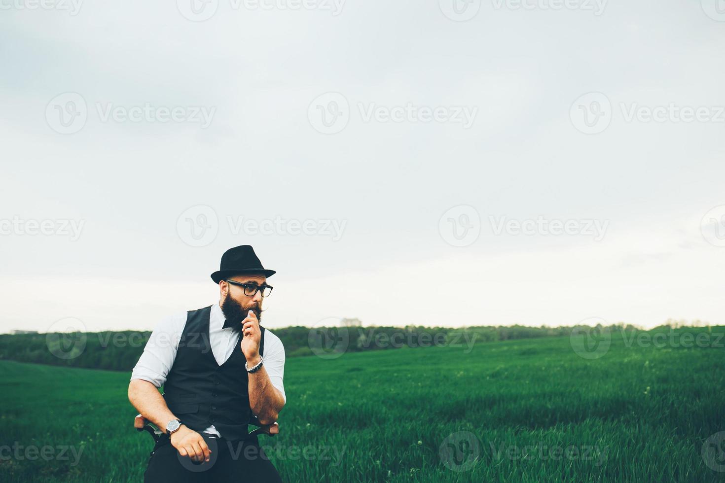 man with a beard, thinking in the field photo