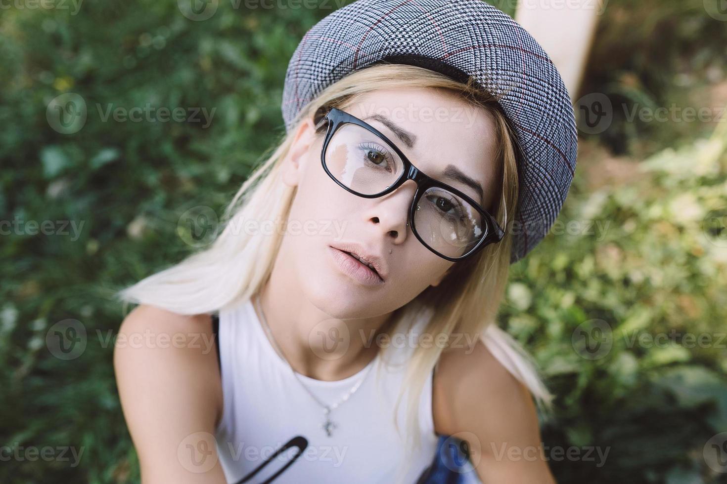 pretty girl sitting and looking at the camera photo