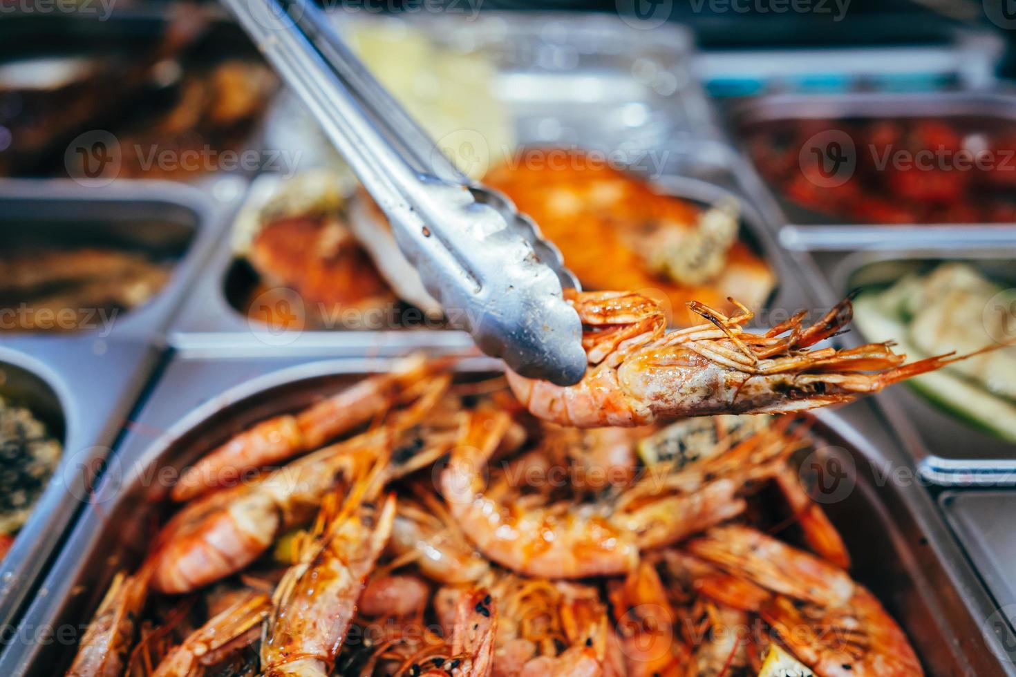 tray with many fried shrimp in the street restaurant photo