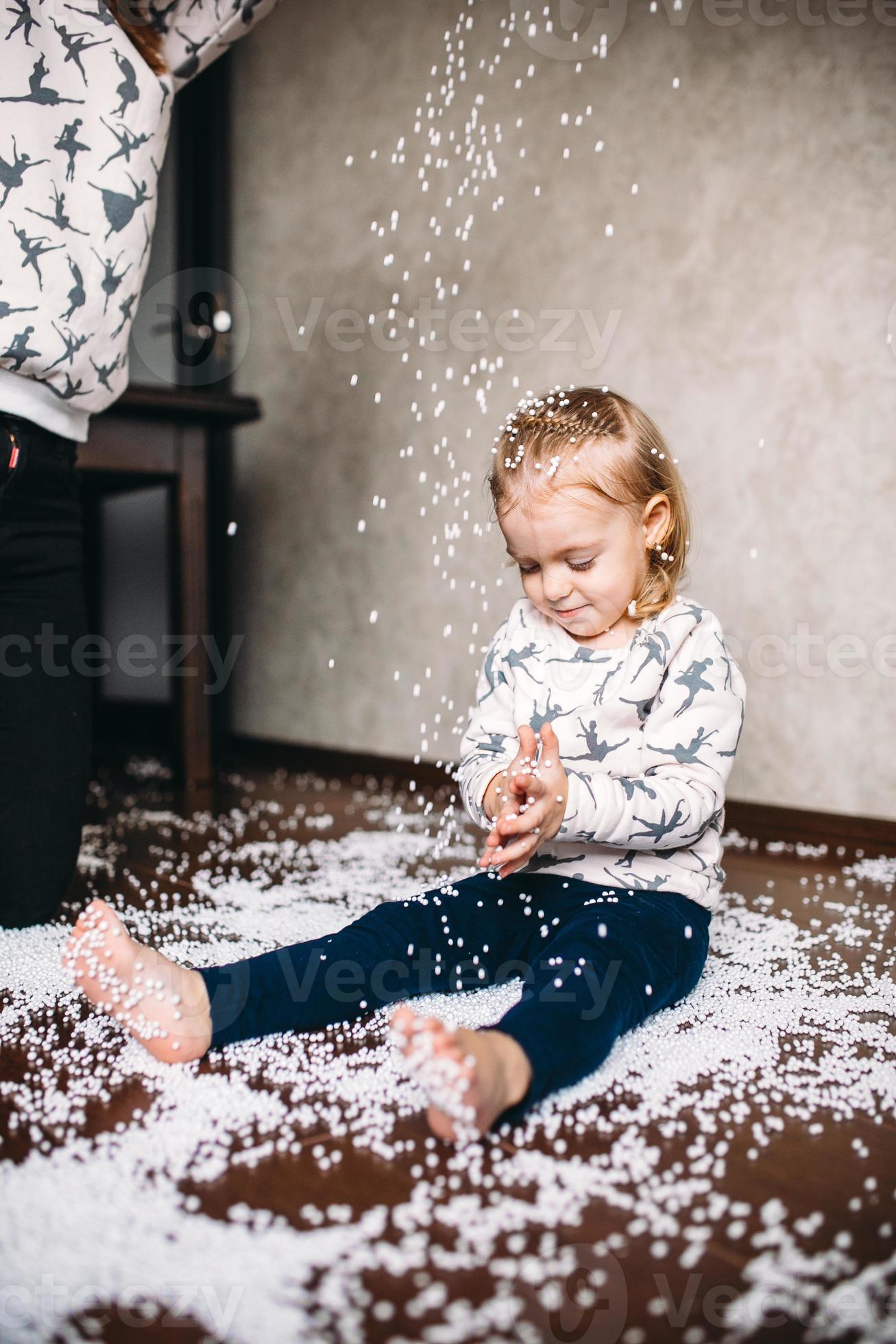 Little girl is playing with foam balls 11530903 Stock Photo at Vecteezy