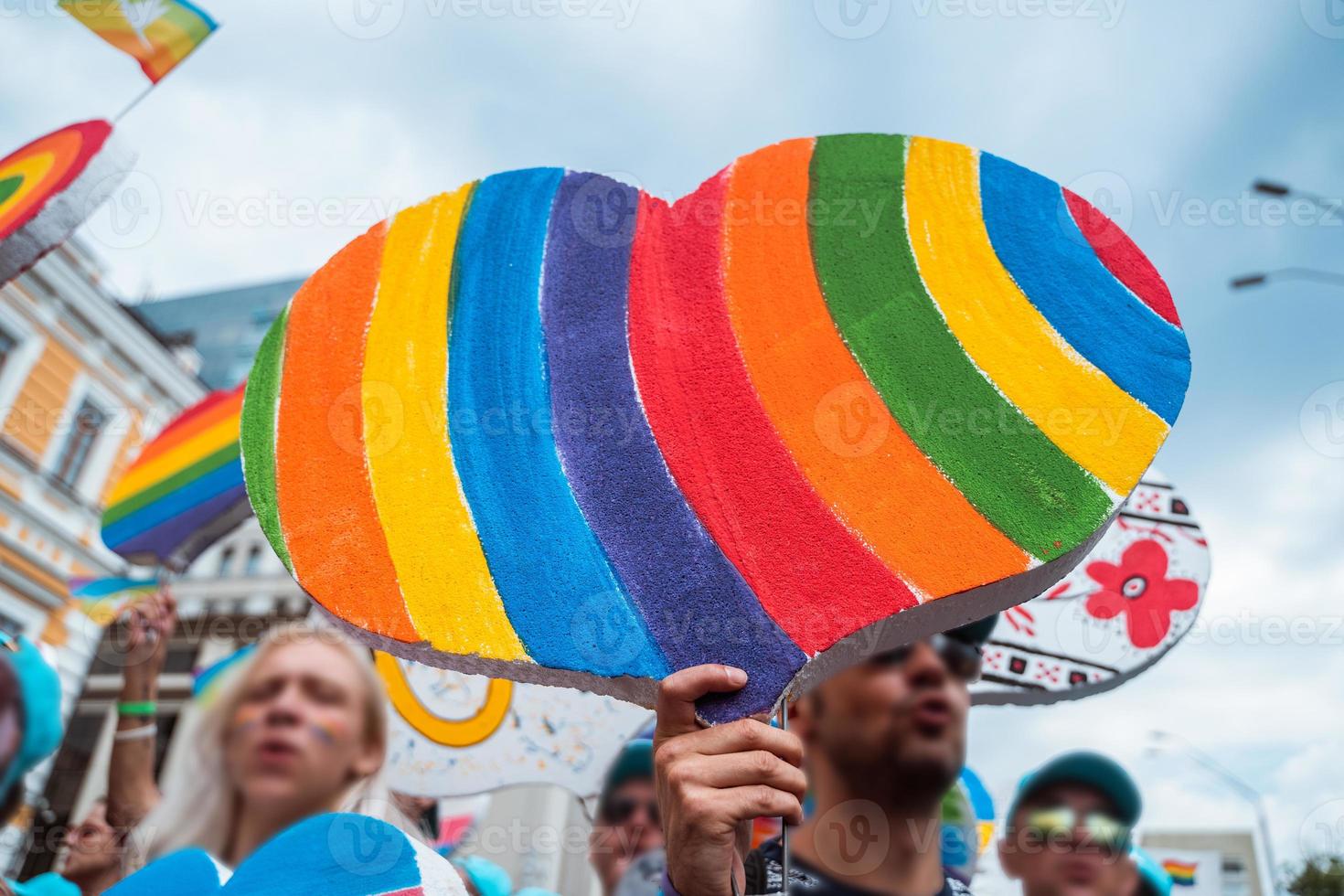 People carry lgbt hearts at the LGBT parade photo
