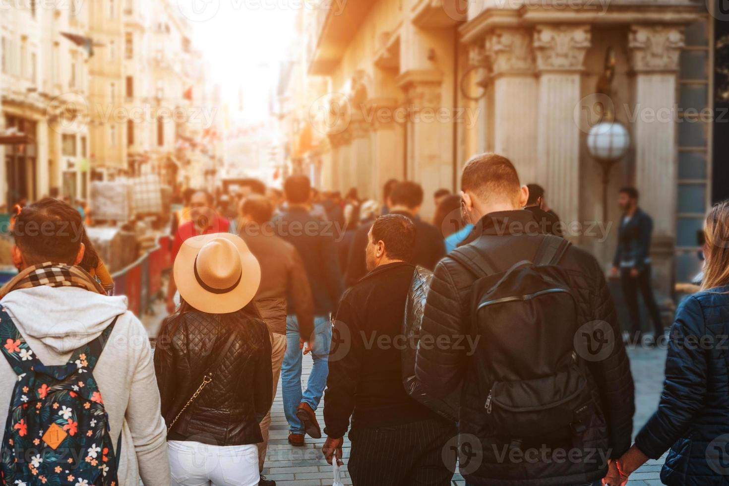 Unrecognizable mass of people walking in the city photo