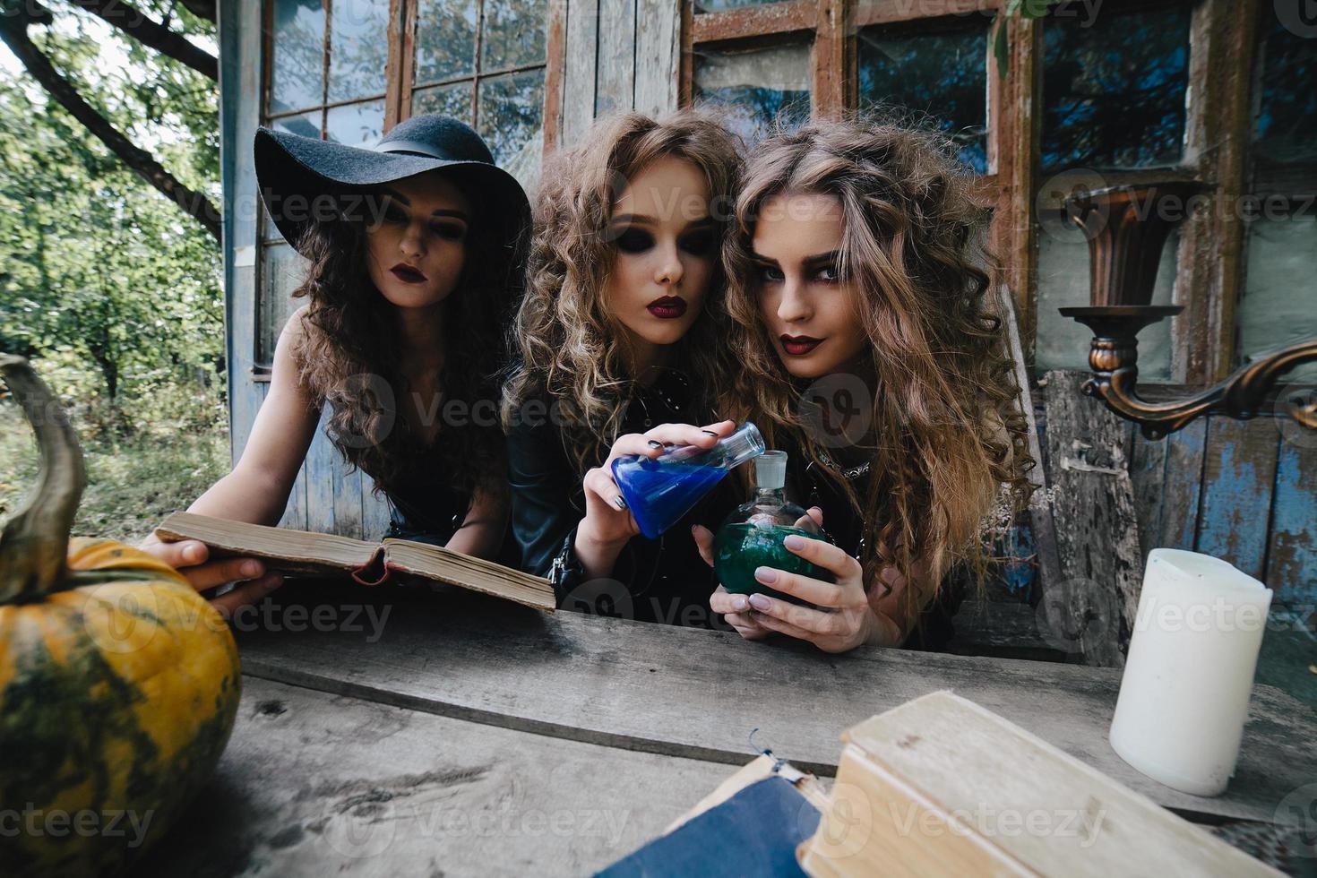 Three vintage witches perform magic ritual photo