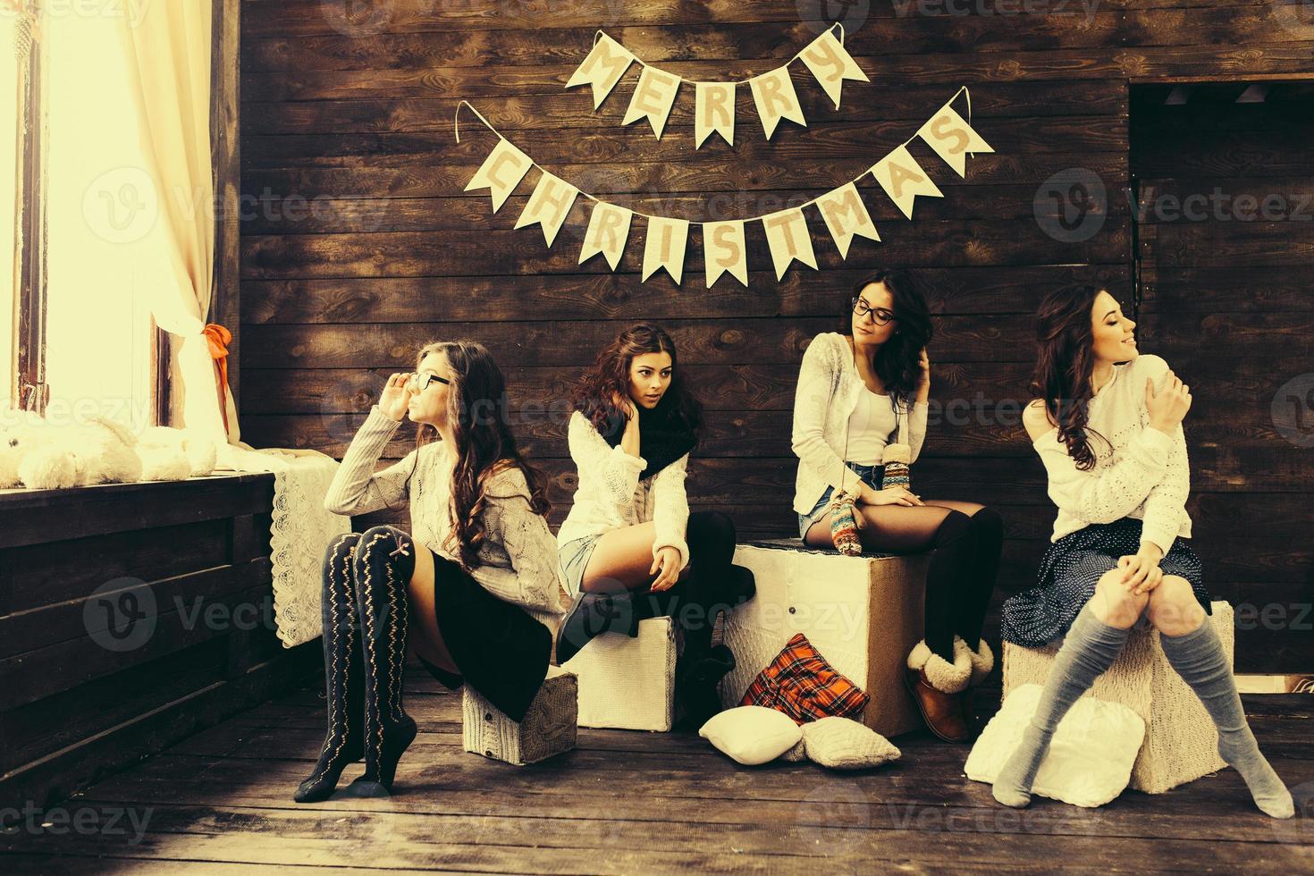 Four charming model posing on a vintage New Year's background photo