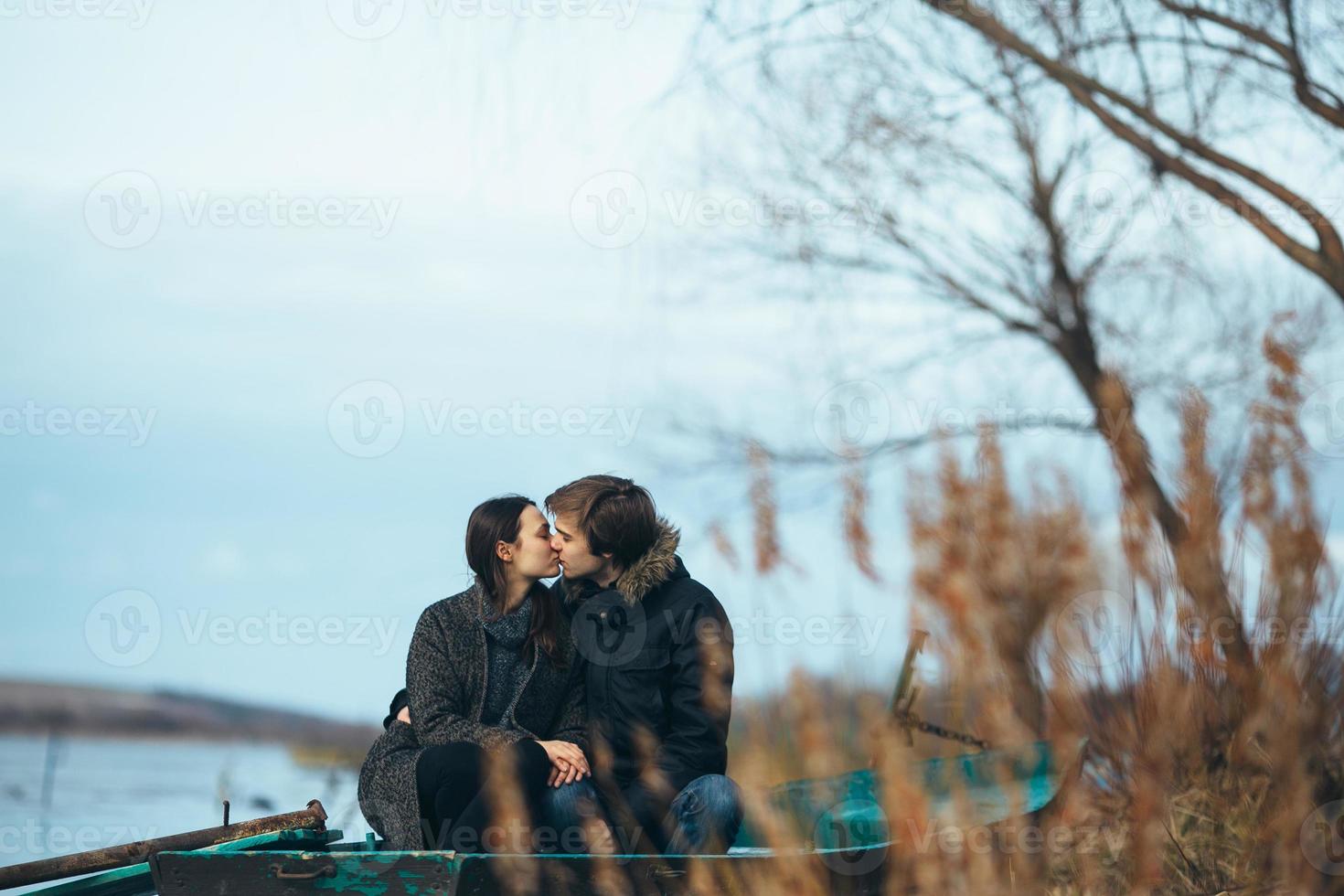young beautiful couple on the ice of a frozen lake photo