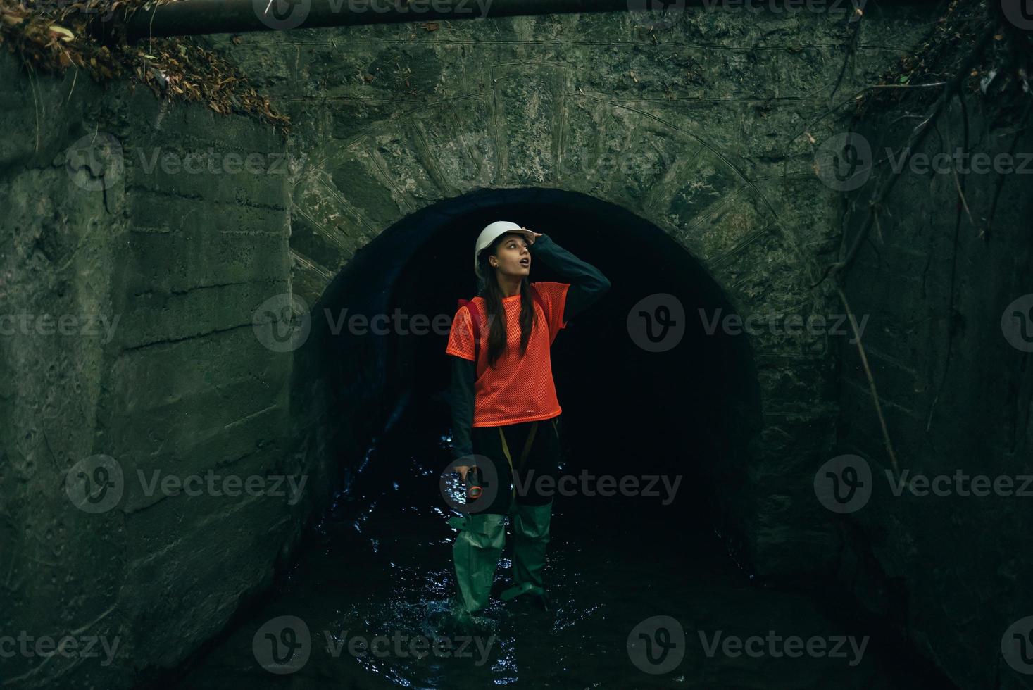 A young woman digger comes out of a rain collector photo