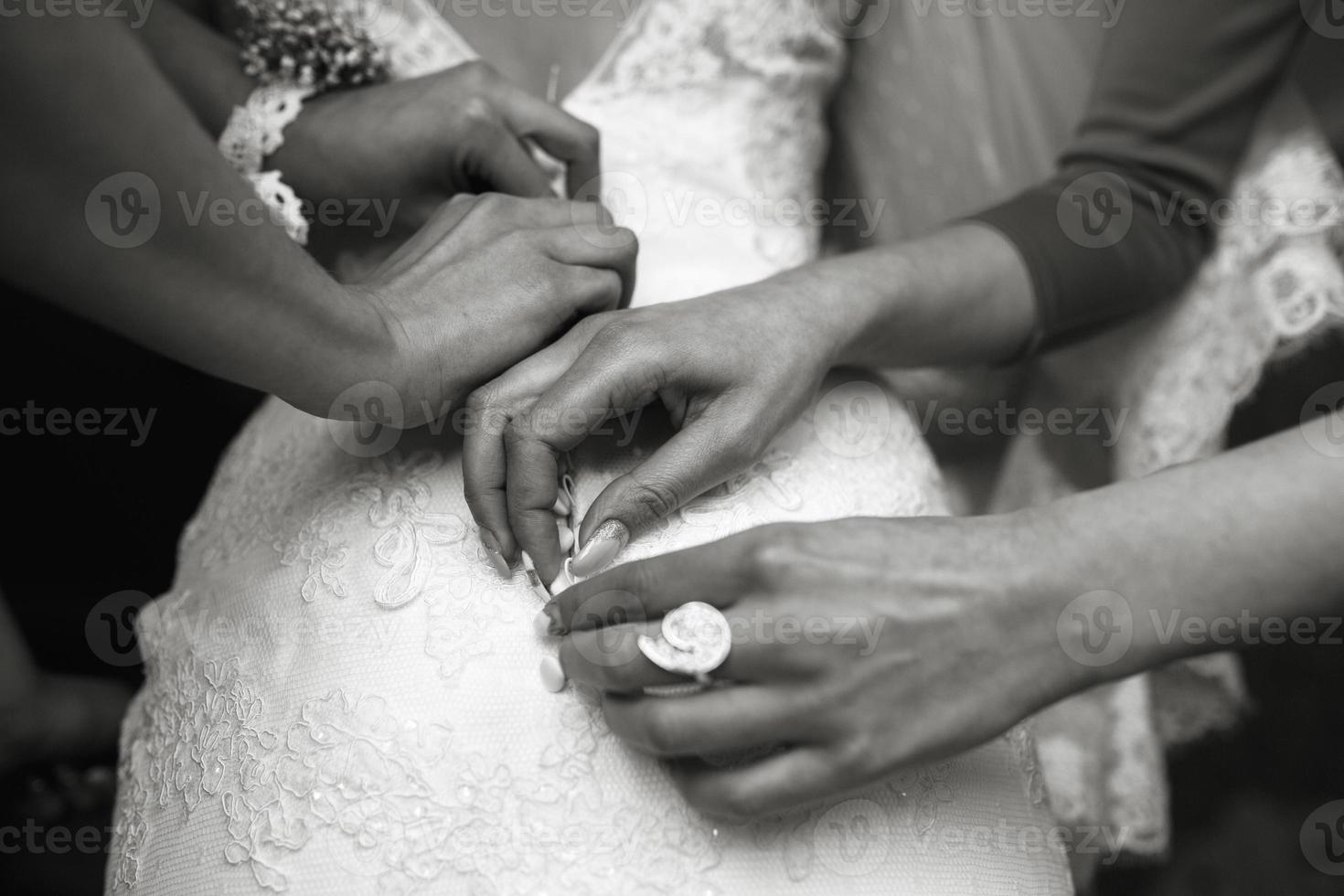 Bride putting on her dress photo