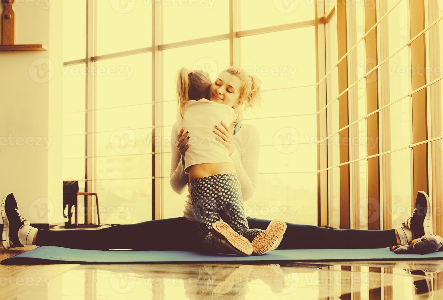 Mother and daughter hugging in the gym photo