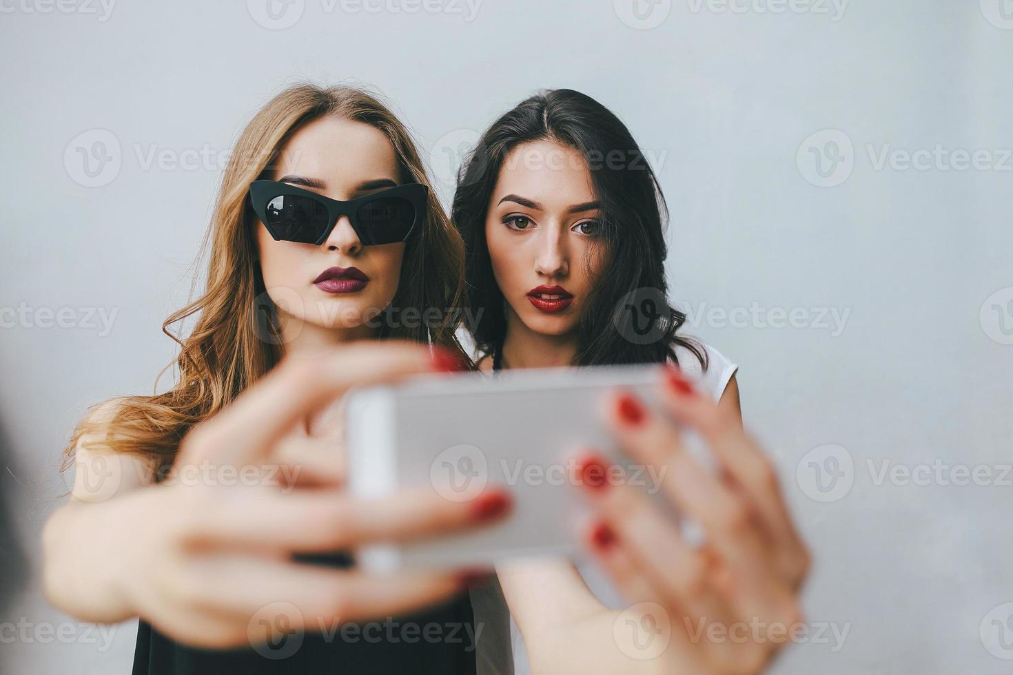 Two girlfriends taking a selfie photo