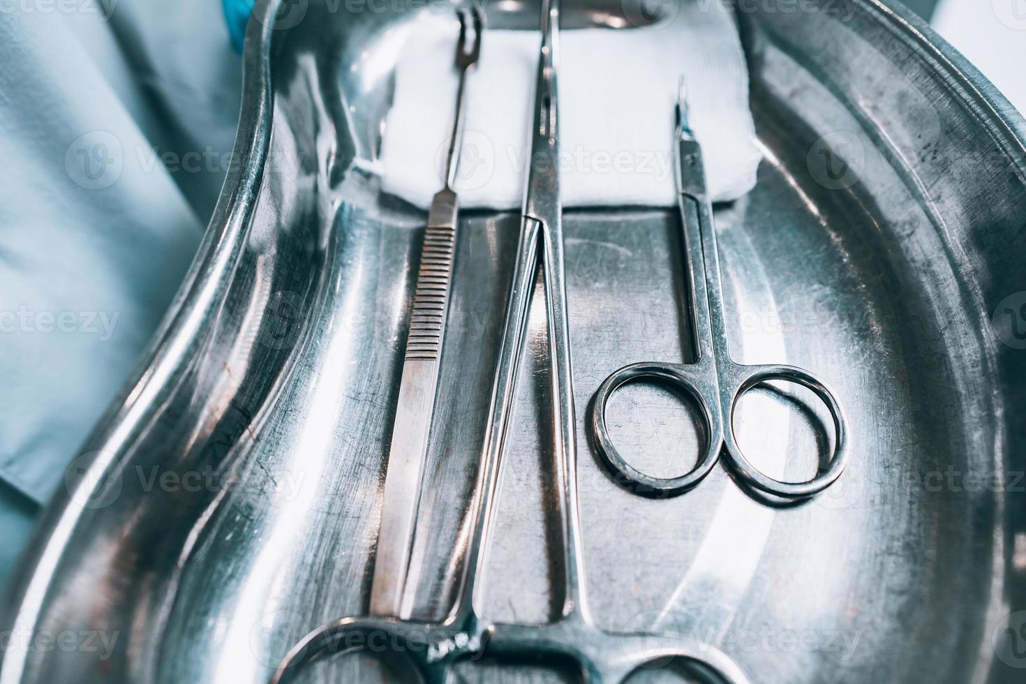 Several surgical instruments lie on a tray photo