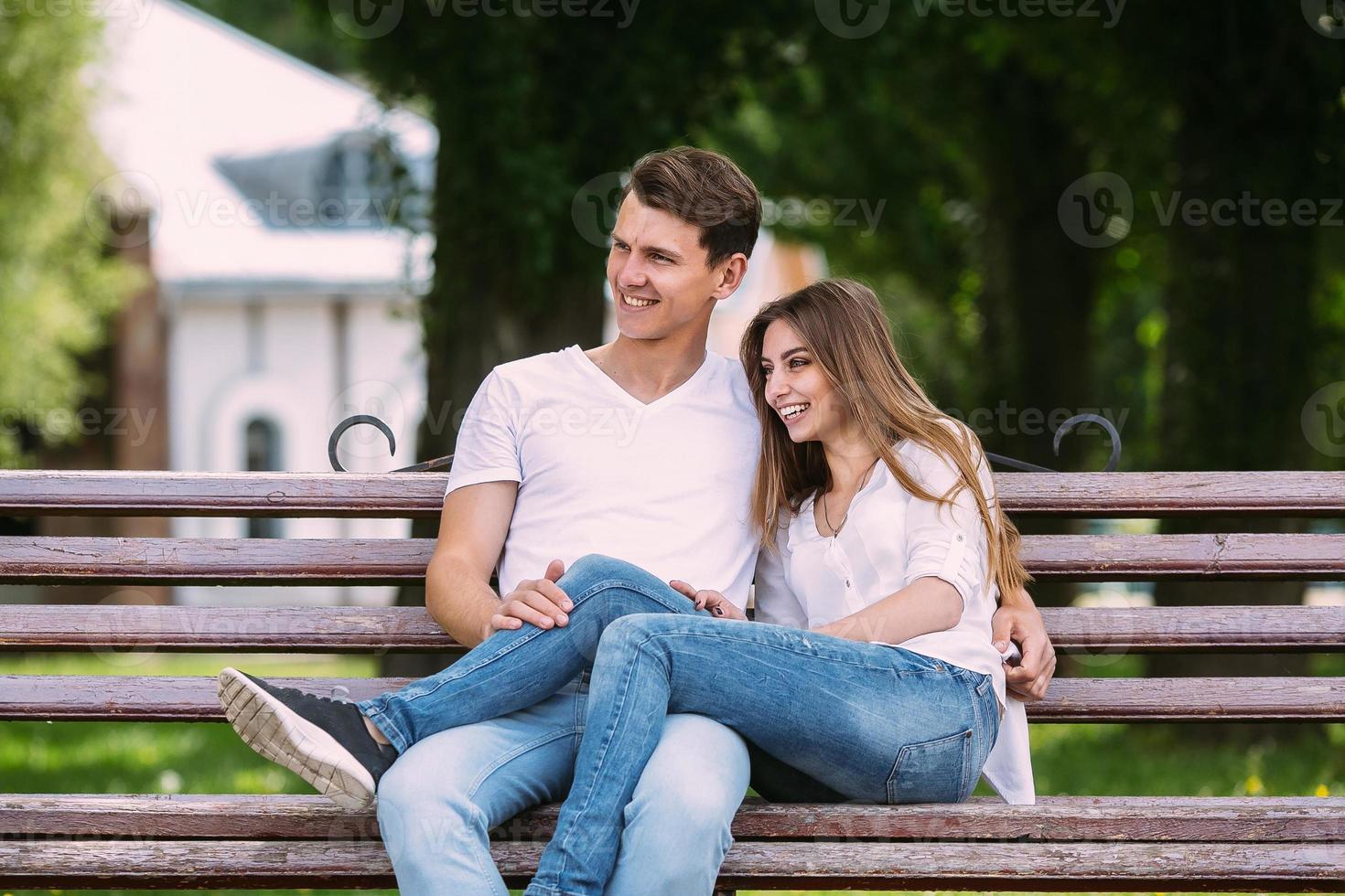 man and woman on a bench in the park photo