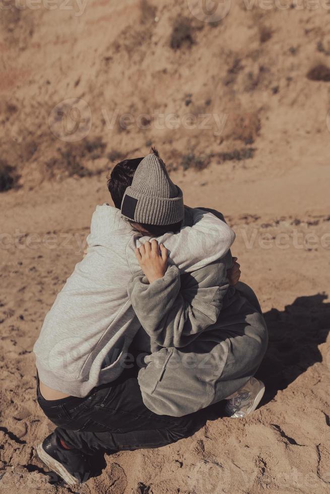 A man and a woman enjoy each other on the seashore. photo