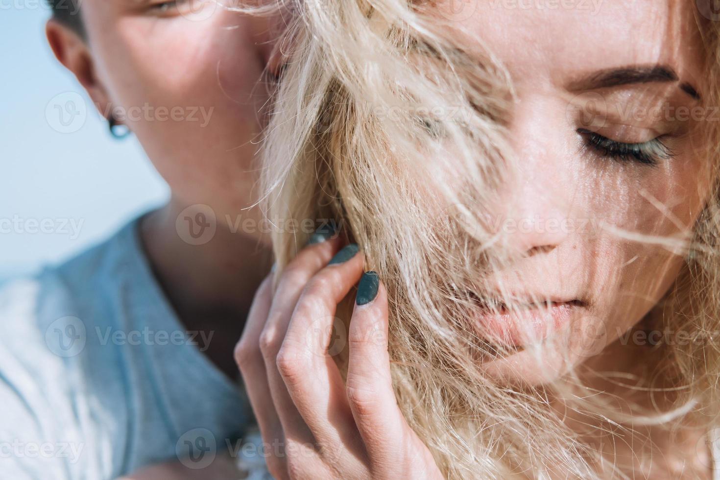 Close-up of guy hugging her girlfriend photo