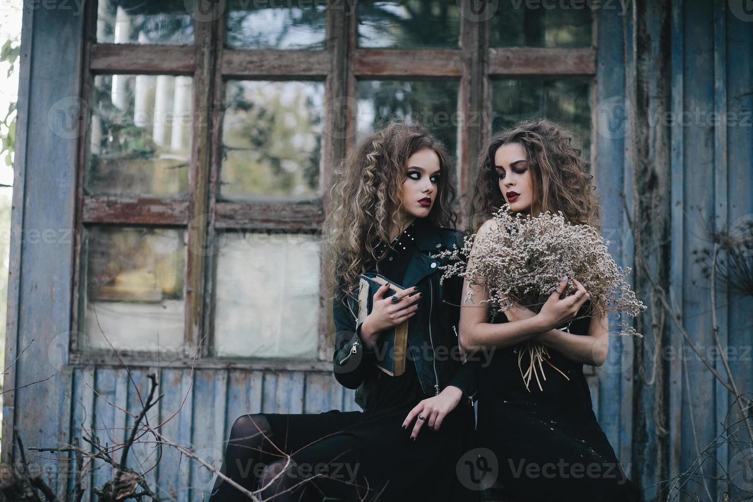 Two vintage witches gathered eve of Halloween photo