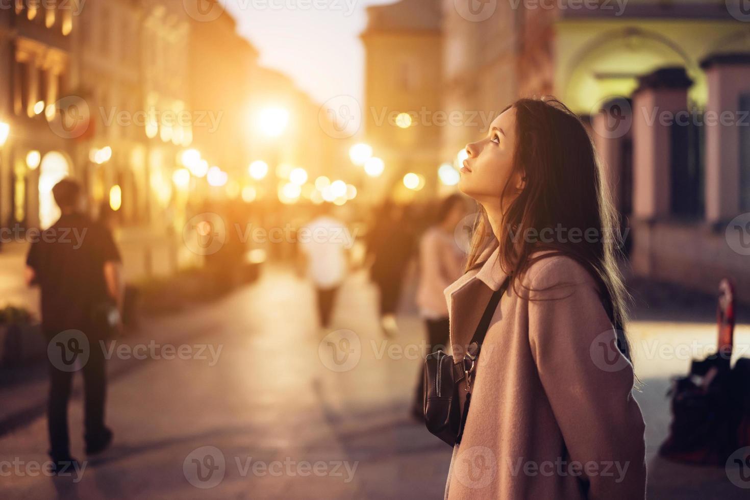 Beautiful girl in the evening on the street photo