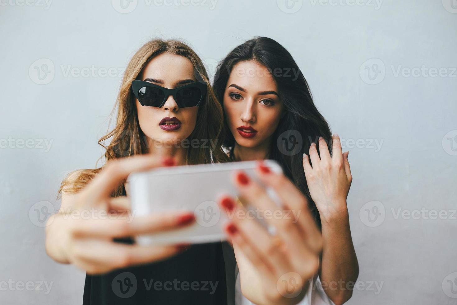 Two girlfriends taking a selfie photo