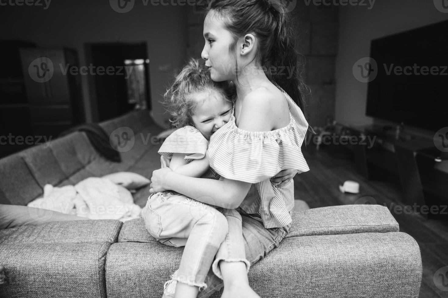 Elder and younger daughter on the big couch photo