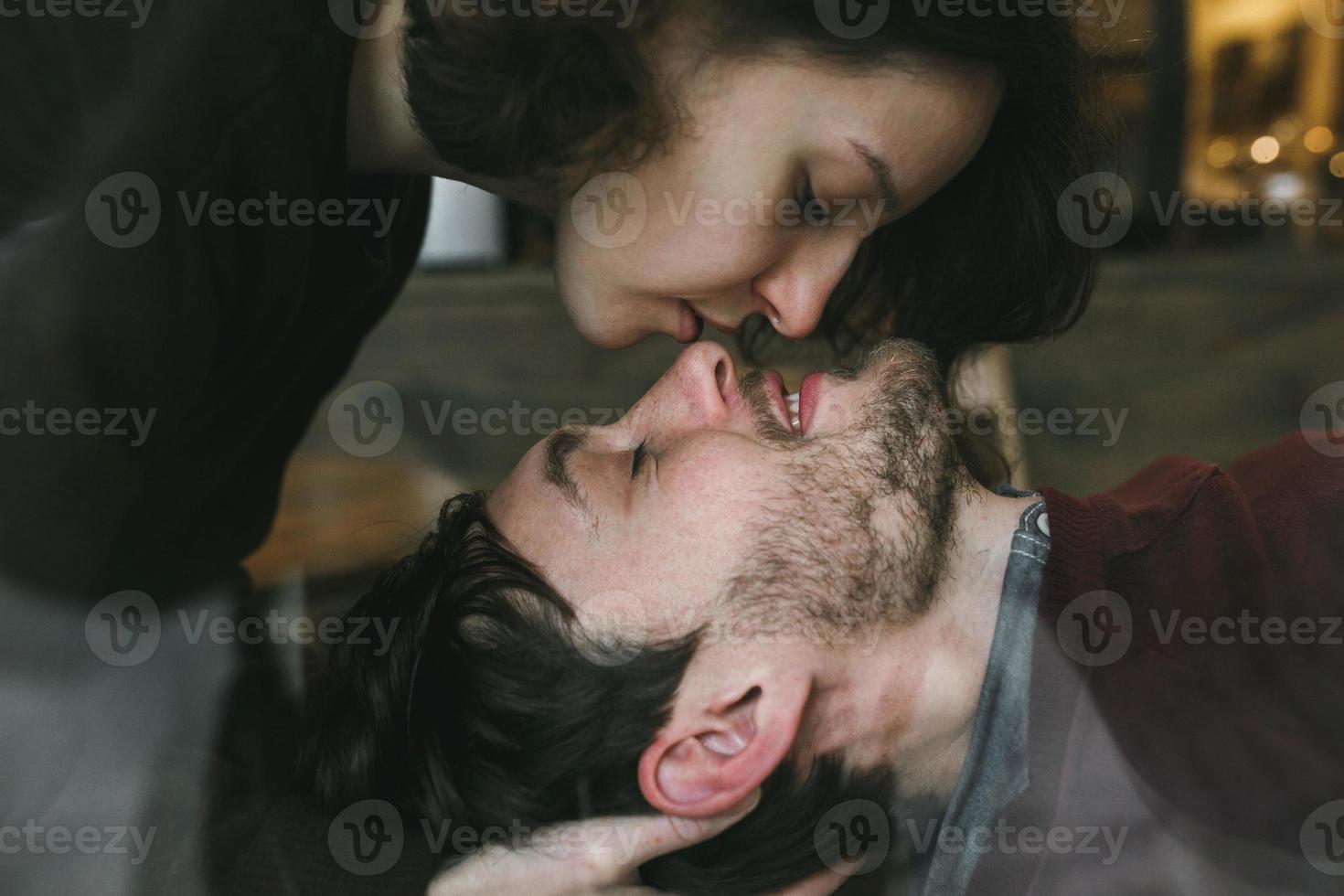 Vintage couple . Girl kiss her boyfriend from above  .Coffee shop photo