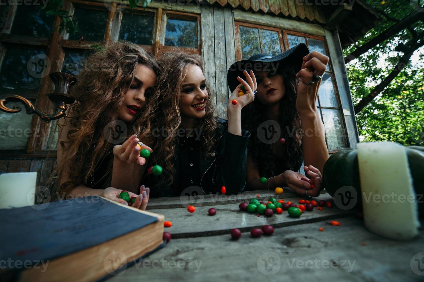 Three vintage witches perform magic ritual photo