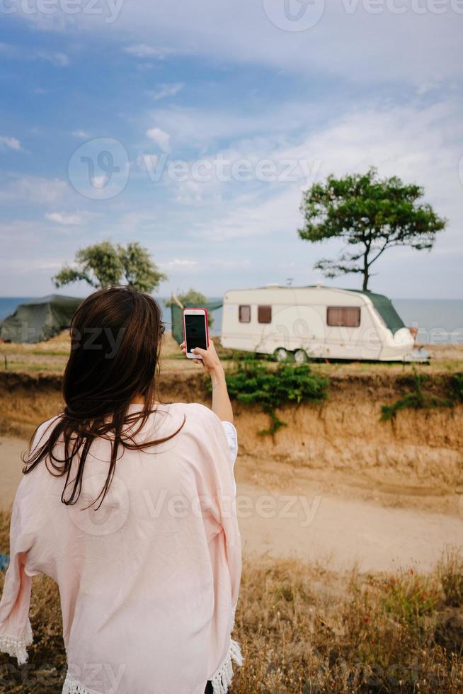 Beautiful, young girl posing on a wild seashore photo