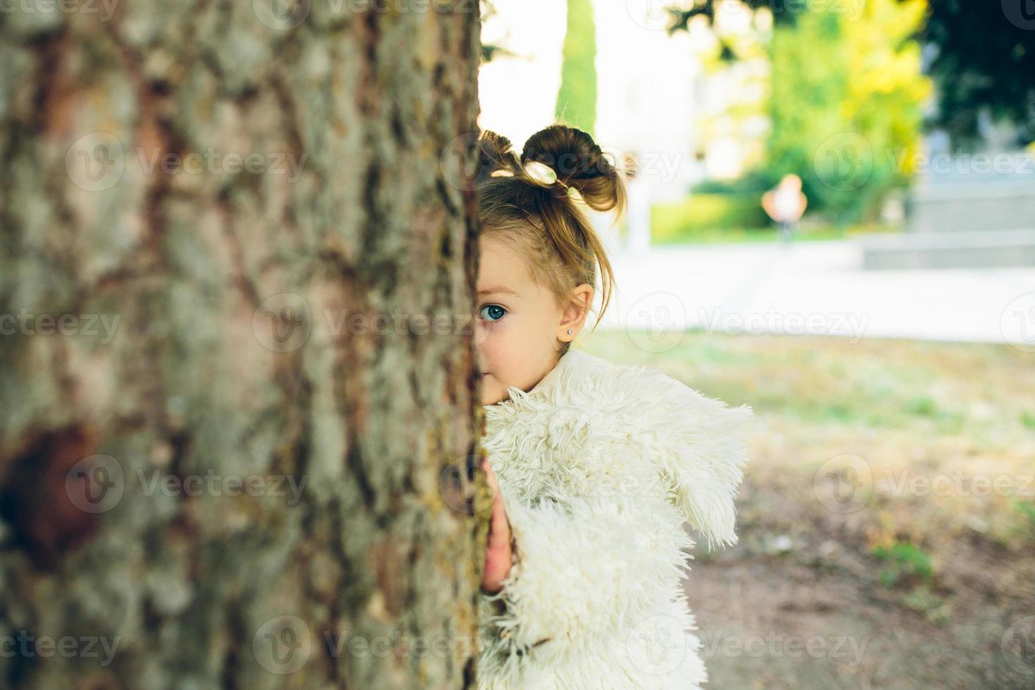 Cute little girl is playing outdoors photo