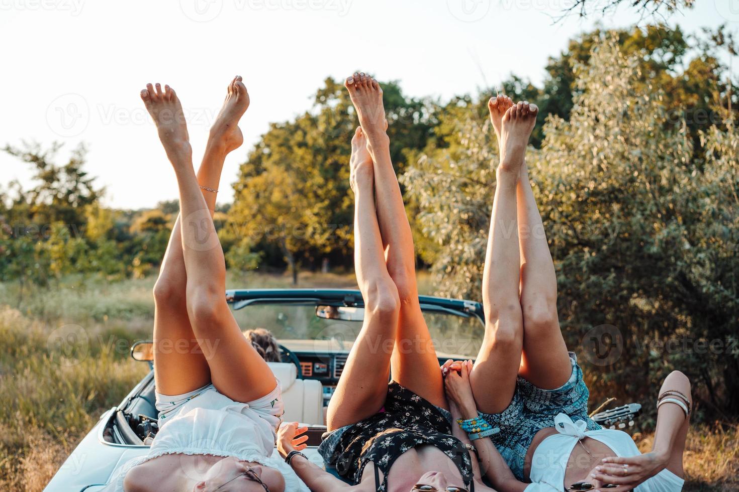Three girls are lying on the trunk photo