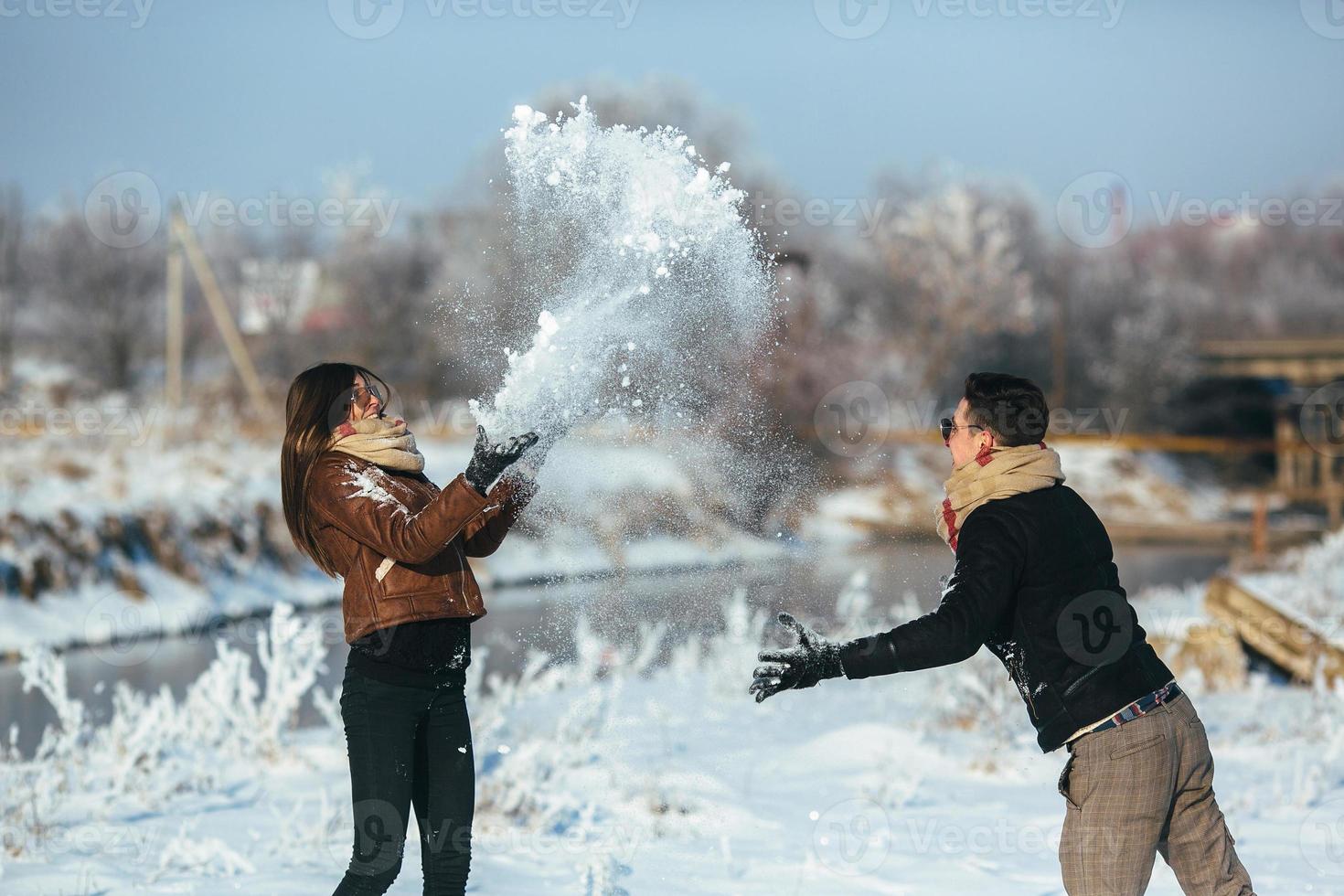 Young couple having fun in winter park photo