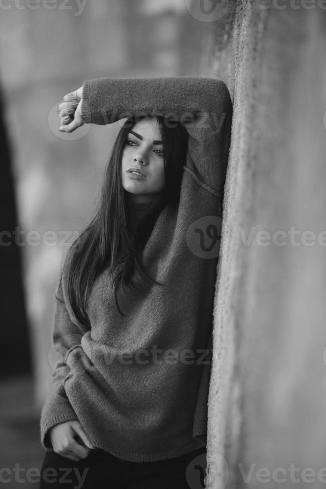 Fashion girl posing against wall photo