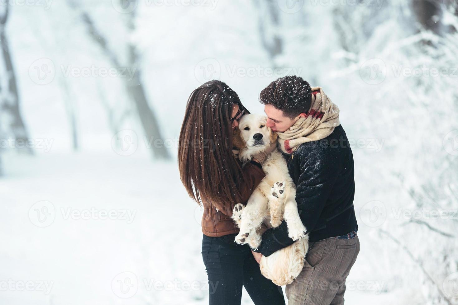 Young couple having fun in winter park photo
