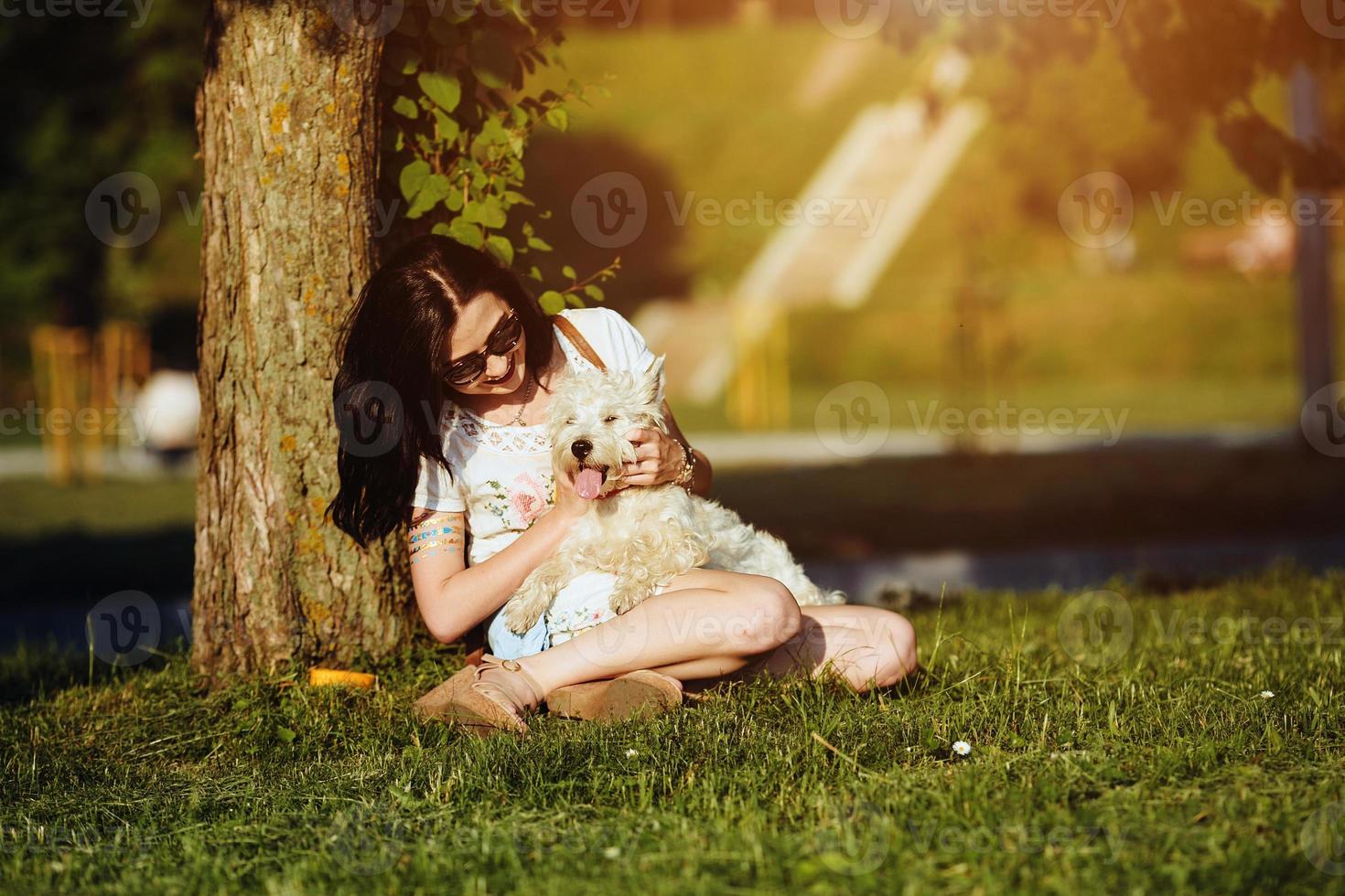 Girl playing with a dog photo