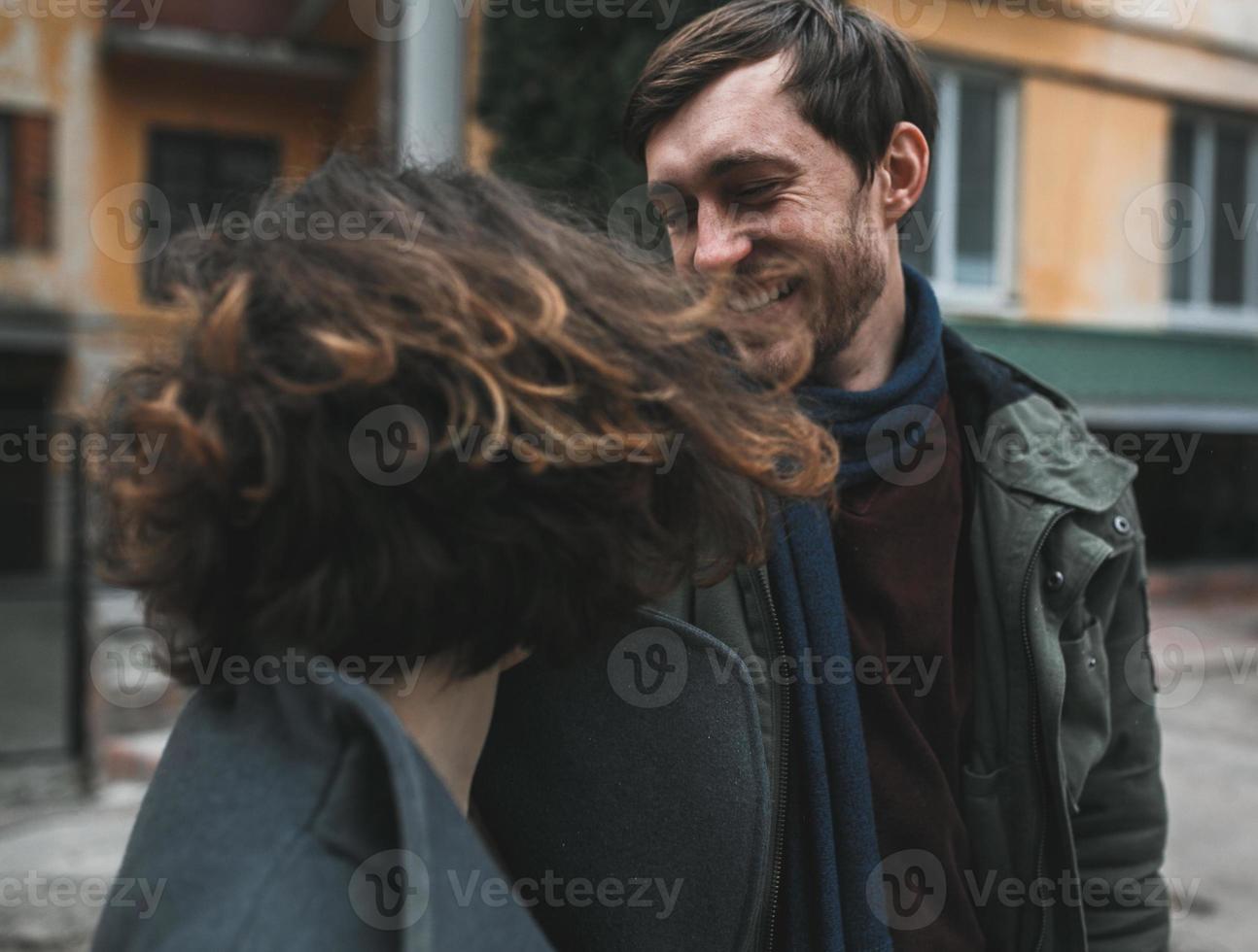 Charming couple in a dress walking down the street photo