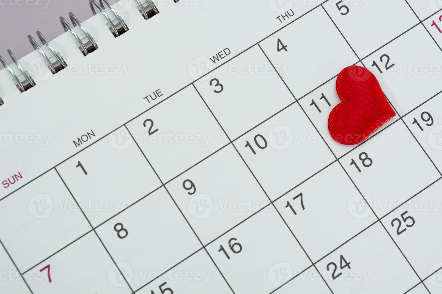 Red heart shape on the date of the 11th day in the calendar. photo