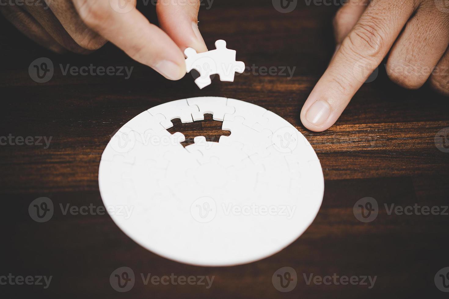 Business woman person hand with puzzle piece idea for strategy and solution. Closeup part of two white jigsaw connect together. Concept of join cooperation success teamwork-problem corporate team. photo