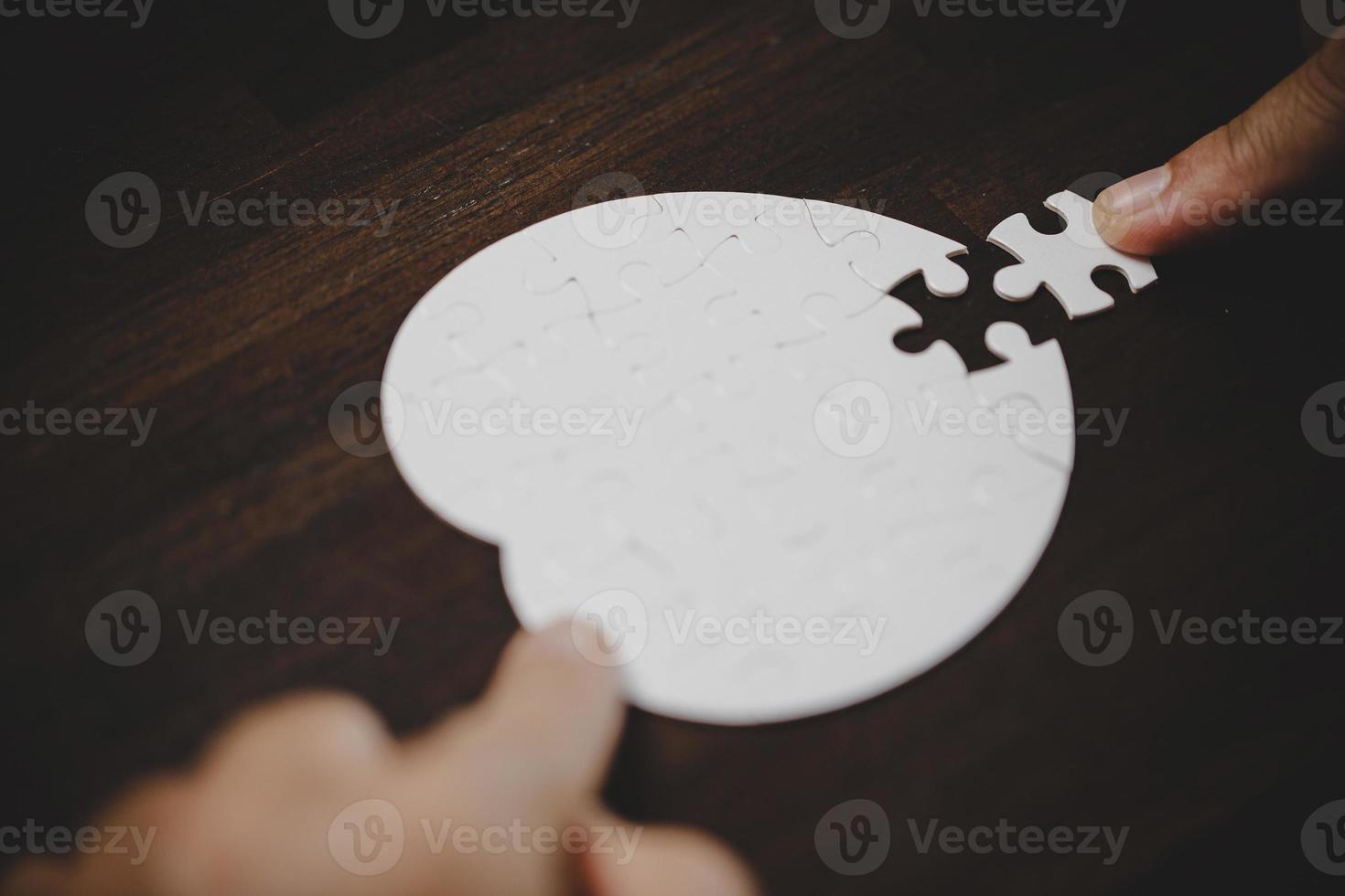 Business woman person hand with puzzle piece idea for strategy and solution. Closeup part of two white jigsaw connect together. Concept of join cooperation success teamwork-problem corporate team. photo