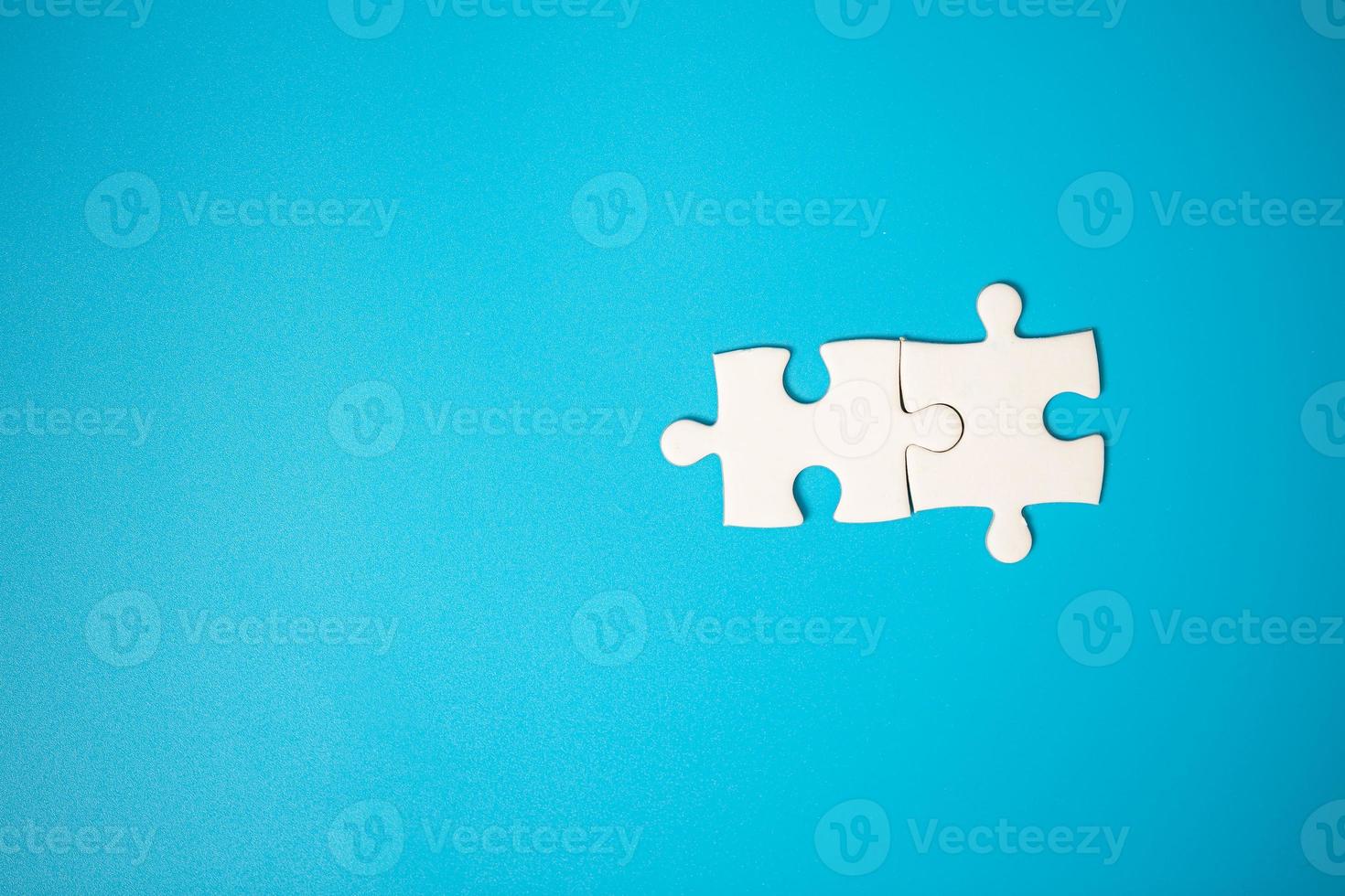 White part of jigsaw puzzle pieces on blue background. concepts of problem solving, business success, teamwork, Team playing jigsaw game incomplete, Texture photo with copy space for text