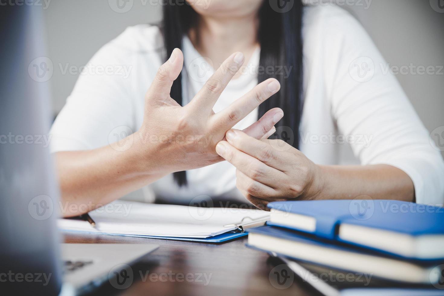 Arthritis person, finger woman ache from working in office. Concept office syndrome hand pain from occupational disease, woman having wrist pain from using laptop computer, wrist pain. photo