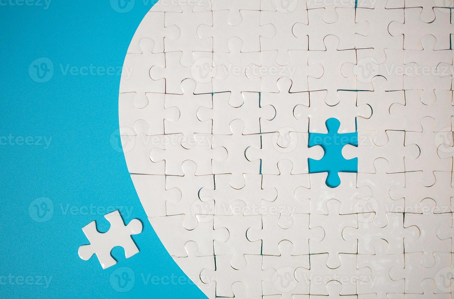 White part of jigsaw puzzle pieces on blue background. concepts of problem solving, business success, teamwork, Team playing jigsaw game incomplete, Texture photo with copy space for text