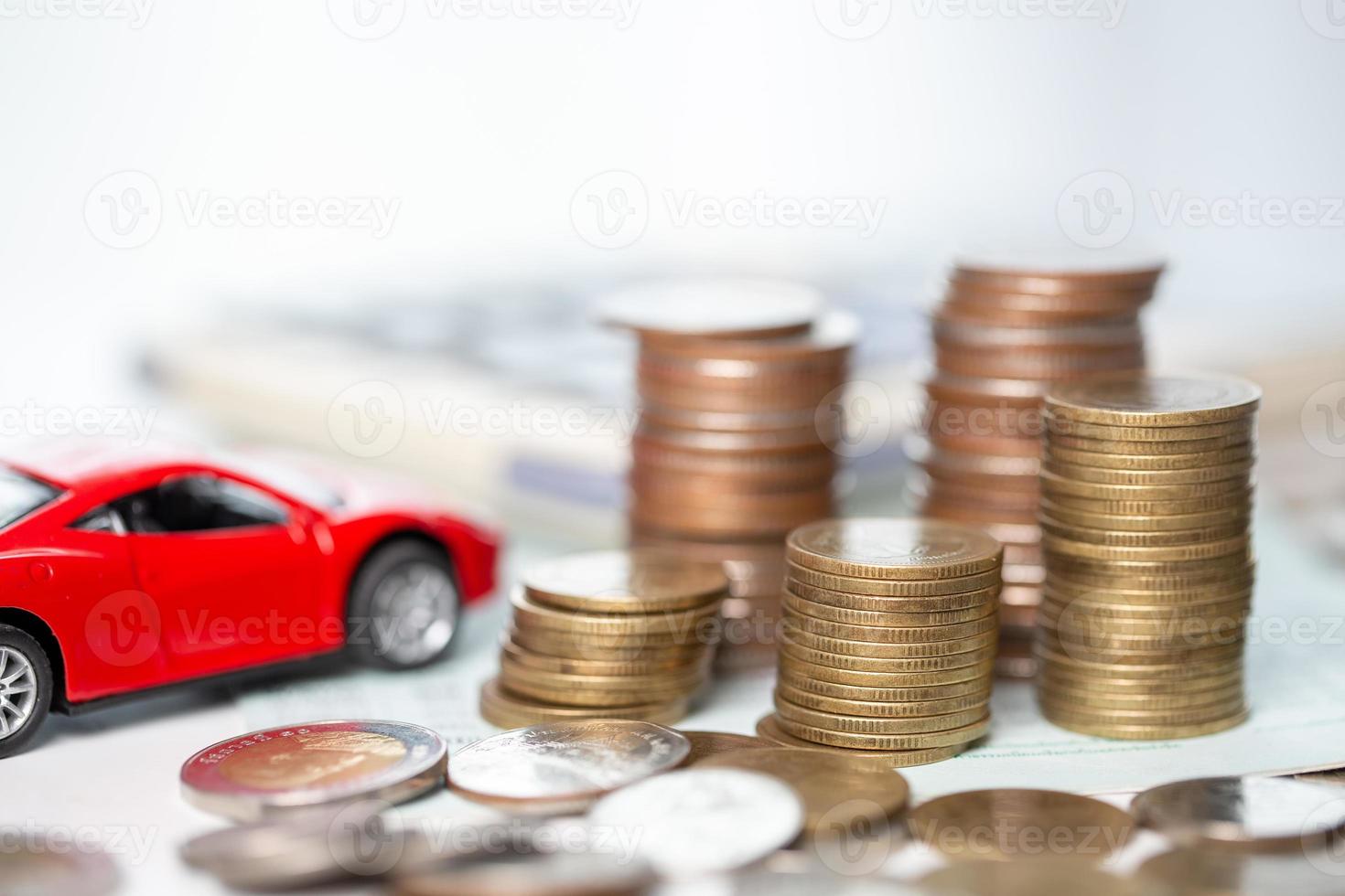 Car toy vehicle with stack coin money on background. Planning to manage transportation finance costs. Concept of car insurance business, saving buy - sale with tax and loan for new car. photo