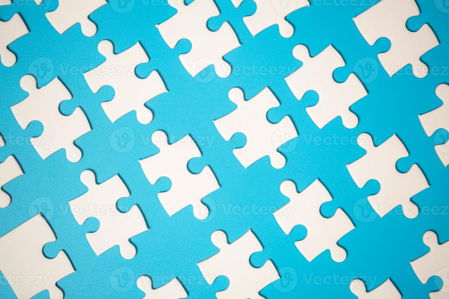 White part of jigsaw puzzle pieces on blue background. concepts of problem solving, business success, teamwork, Team playing jigsaw game incomplete, Texture photo with copy space for text