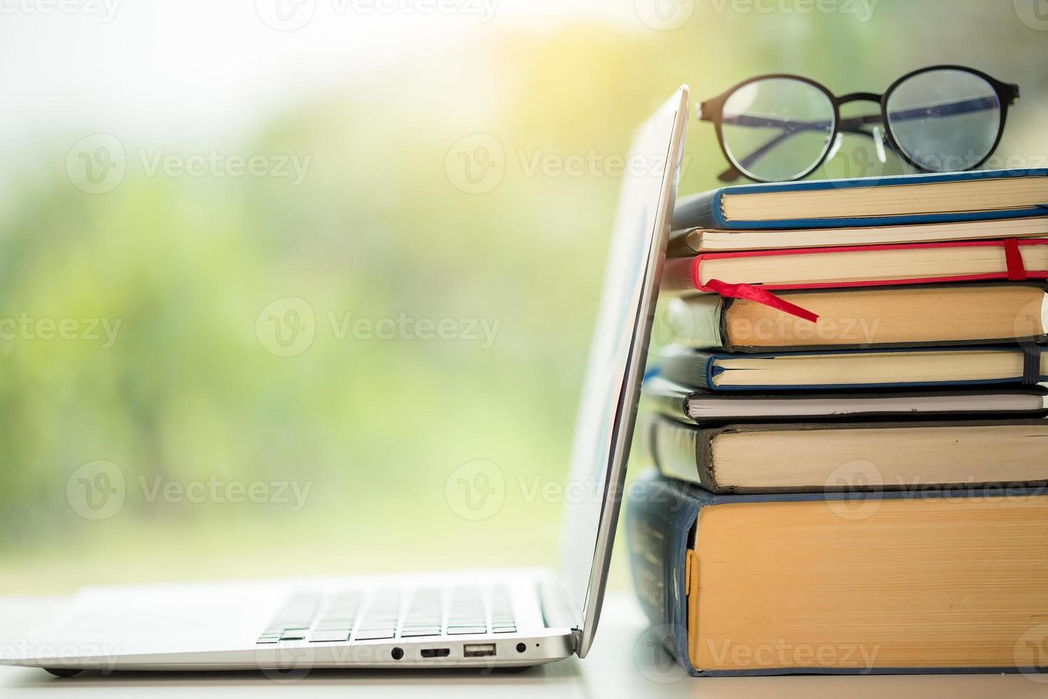 Object education green nature background with stack of ancient books or old bible, open paper book on wooden table with copy space. concept of back to school, research study photo