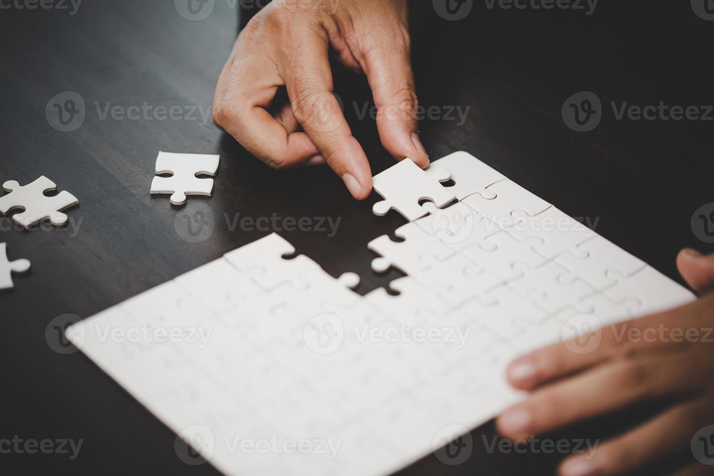 Business woman person hand with puzzle piece idea for strategy and solution. Closeup part of two white jigsaw connect together. Concept of join cooperation success teamwork-problem corporate team. photo