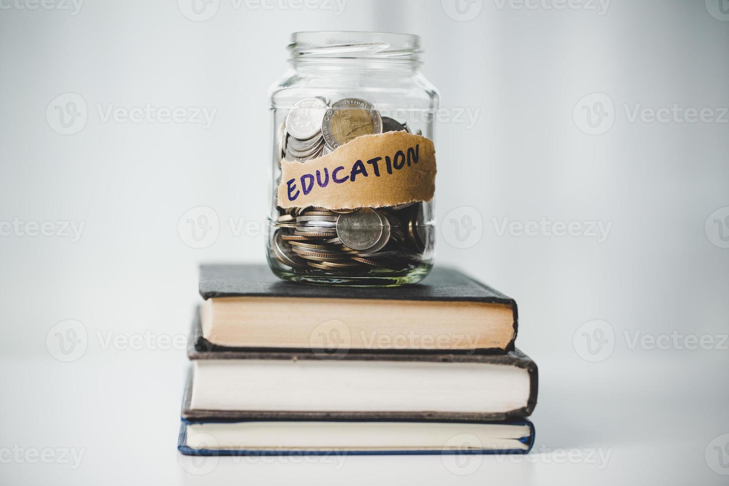 close-up education object with stack money coin-cash dollar and glass jar on background. Concept to saving money income for study, Calculating student finance costs and investment budget loan photo