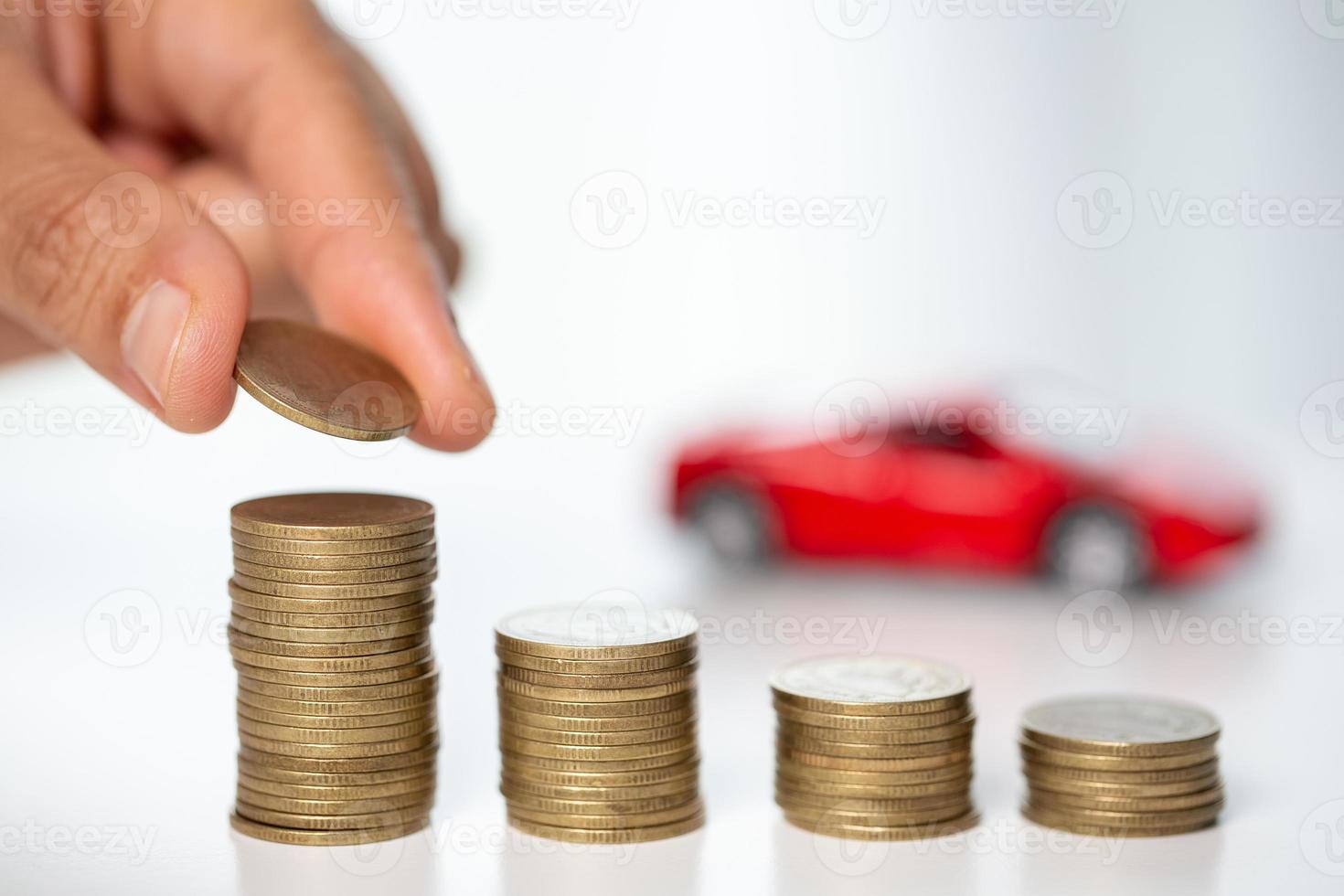 Car toy vehicle with stack coin money on background. Planning to manage transportation finance costs. Concept of car insurance business, saving buy - sale with tax and loan for new car. photo