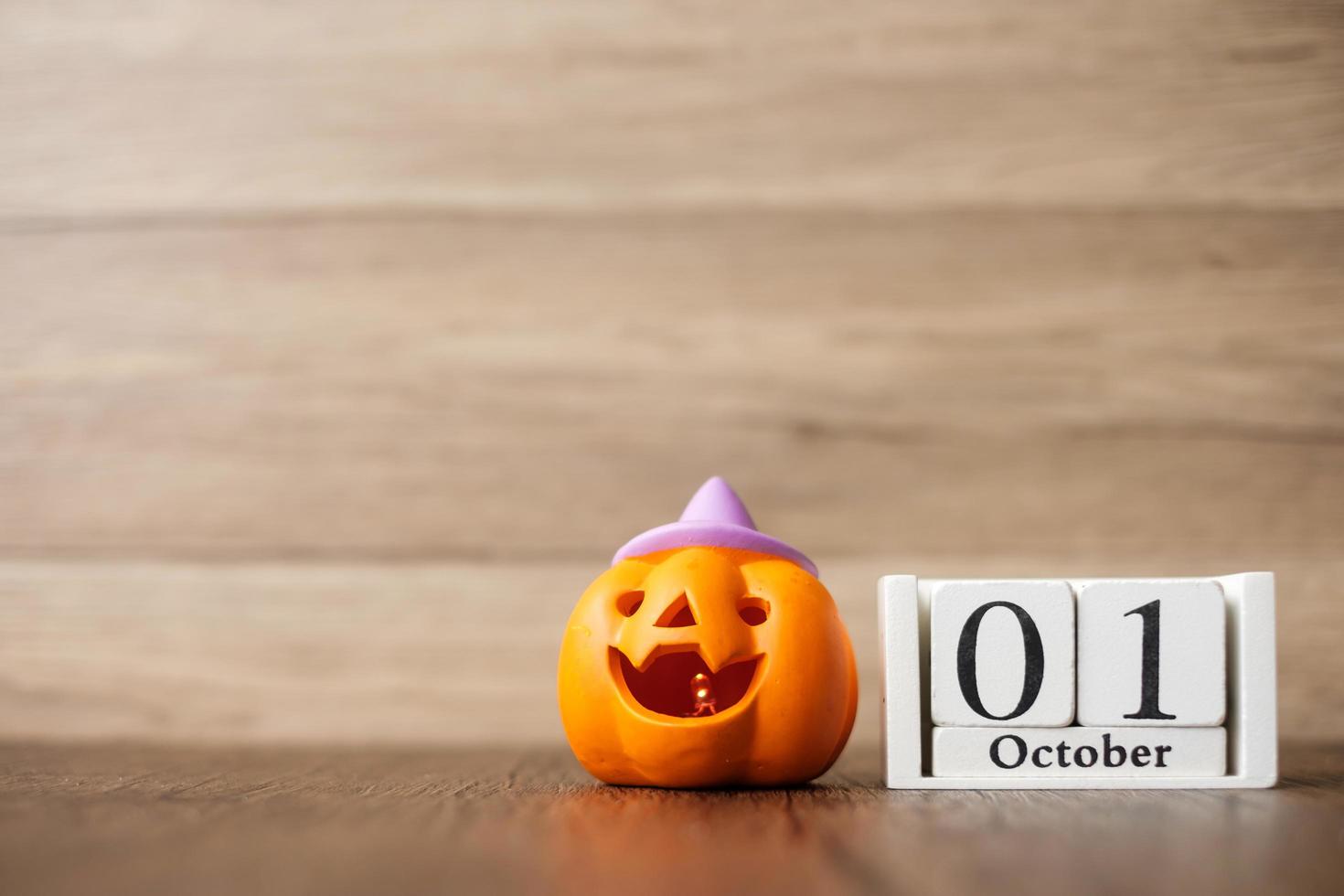 Happy Halloween day with Jack O lantern pumpkin and 1 October calendar. Trick or Threat, Hello October, fall autumn, Festive, party and holiday concept photo