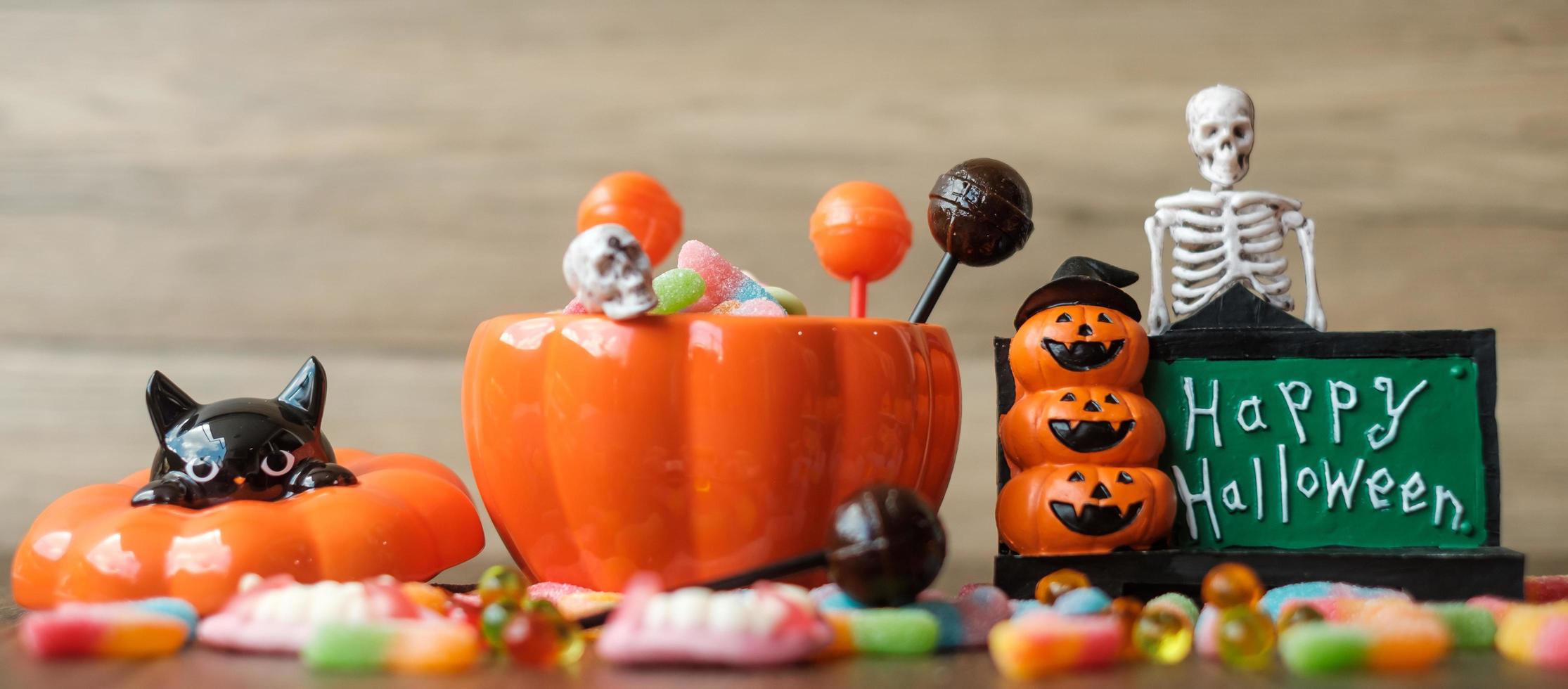 Happy Halloween day with ghost candies, pumpkin bowl, Jack O lantern and decorative. Trick or Threat, Hello October, fall autumn, Festive, party and holiday concept photo