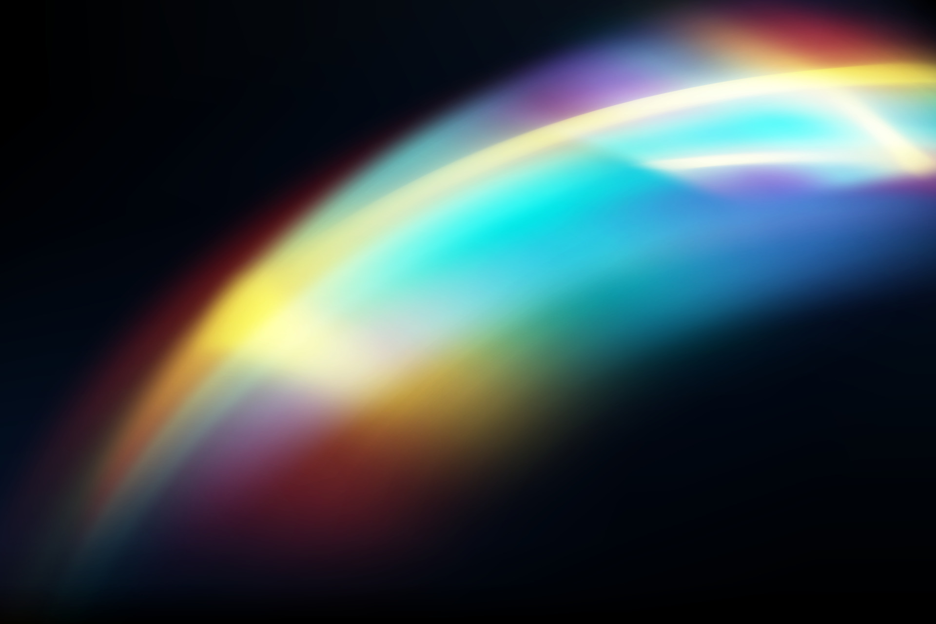 Rainbow highlights on a black background.Glare or reflection from