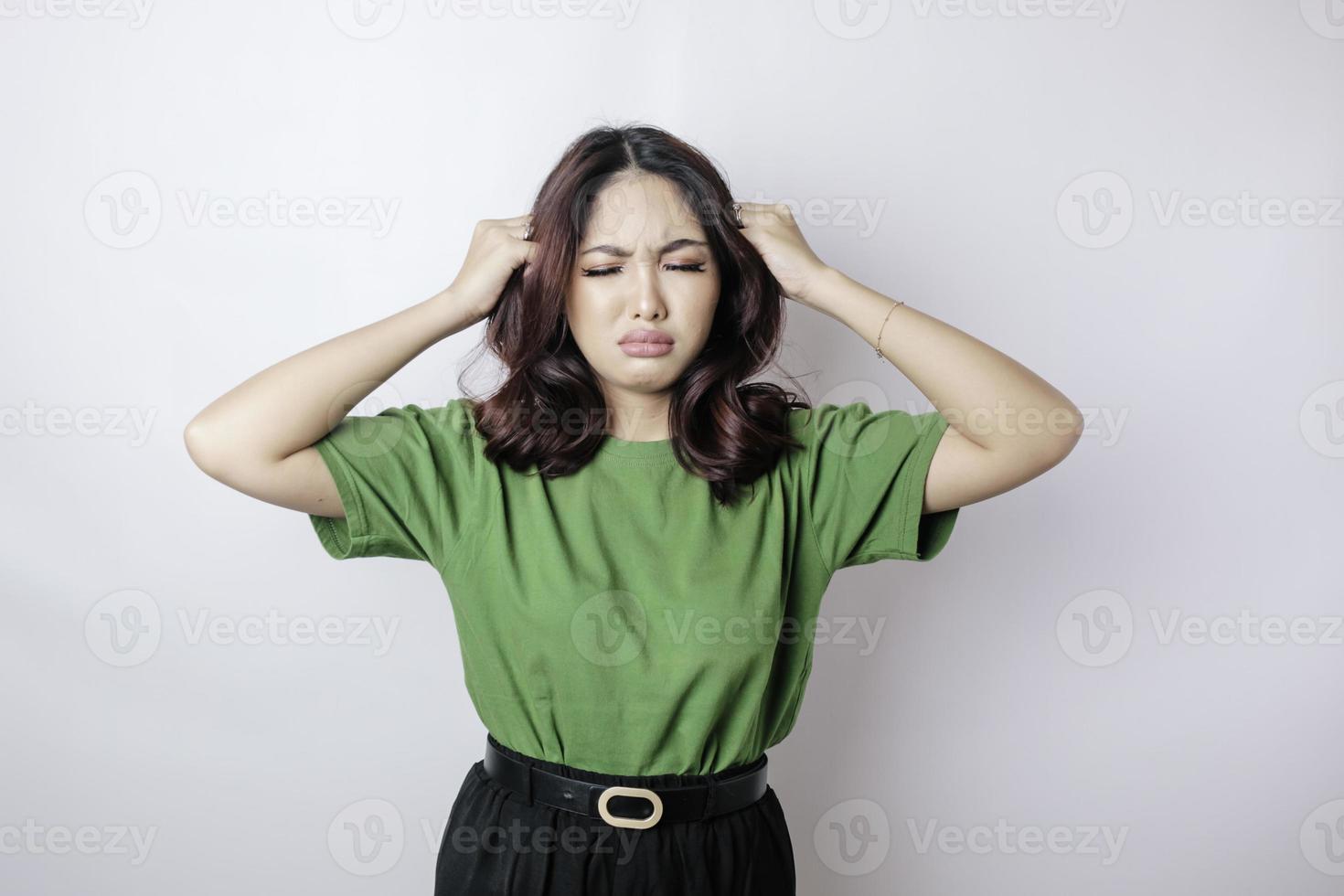 Portrait of young Asian woman isolated by white background feeling frustrated with helpless face expression. photo