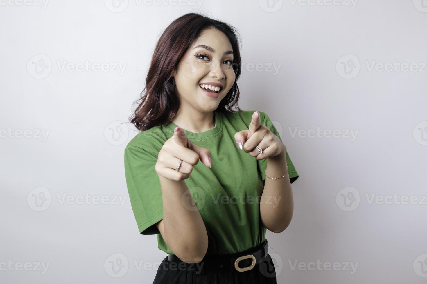 Young beautiful Asian girl standing over isolated white background pointing fingers to camera with happy face. Good energy and vibes. photo