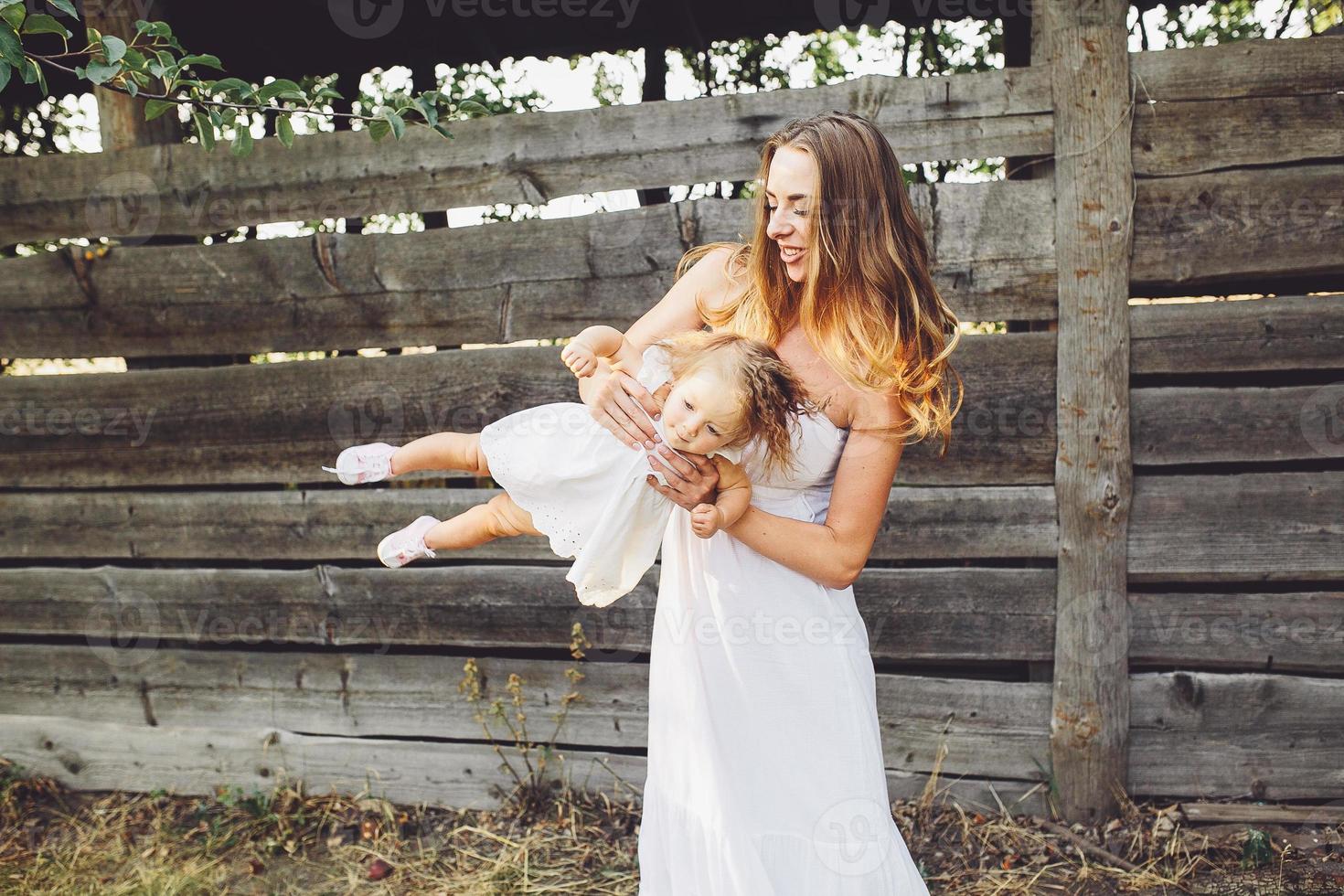 mother playing with his little daughter photo